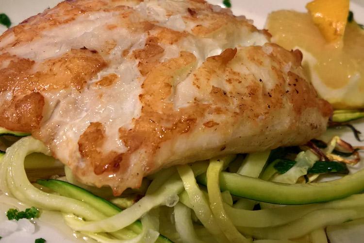 Merluza a la plancha con espirales de calabacín.