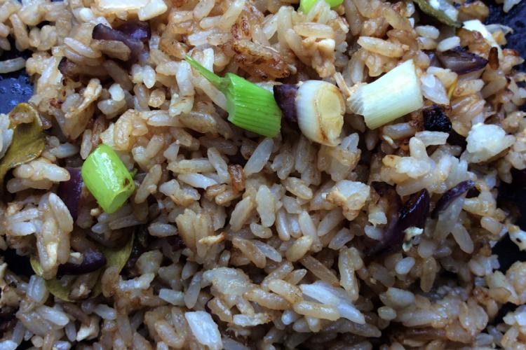 Arroz frito al estilo tailandés con cebolla morada, huevo y cebolletas.