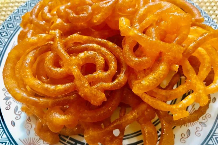 Jalebi, fritos y almibarados, en un plato.