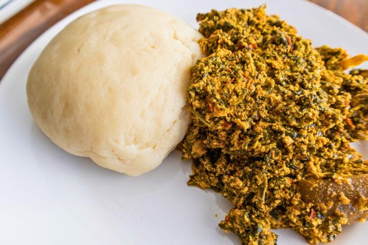 Un plato con sopa de egusi y fufu de ñame.