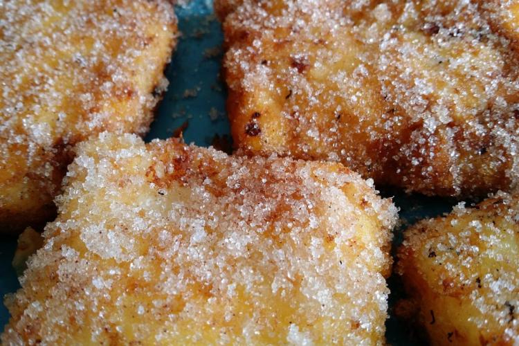 Cuadrados de leche frita espolvoreados con azúcar.
