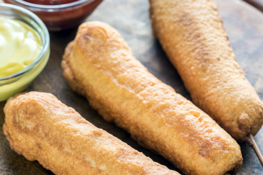 Corn dogs with ketchup and mustard