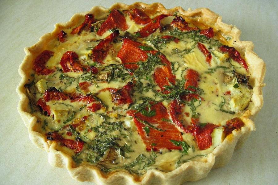 Quiche con pimiento, rúcula y base de masa quebrada.