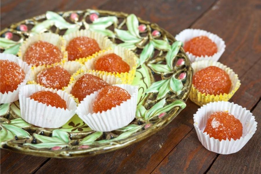 Dulces de zanahoria y coco rallado en moldes de papel rizado.
