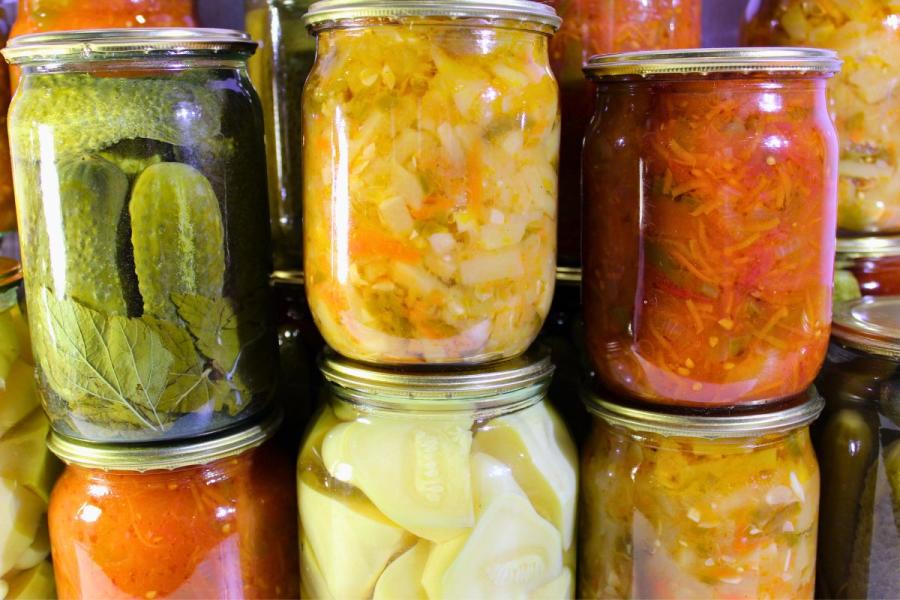 Conservas caseras, incluyendo verduras variadas y tomate.