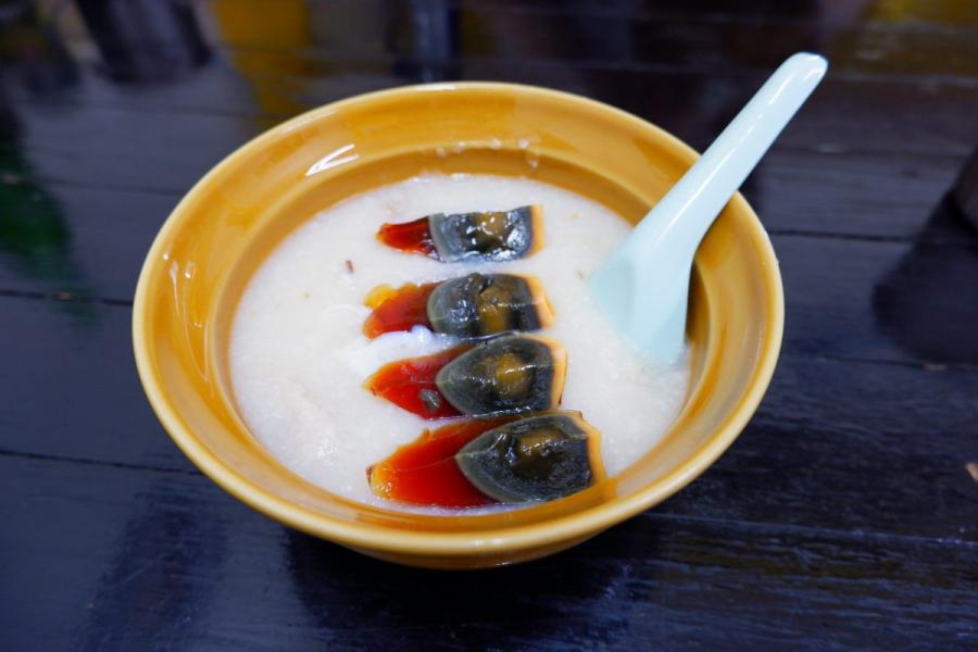 Un cuenco de arroz congee con huevos centenarios.