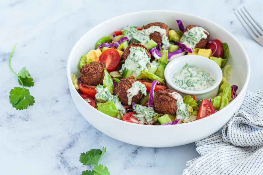 Ensalada con falafel y aliño de tahini.