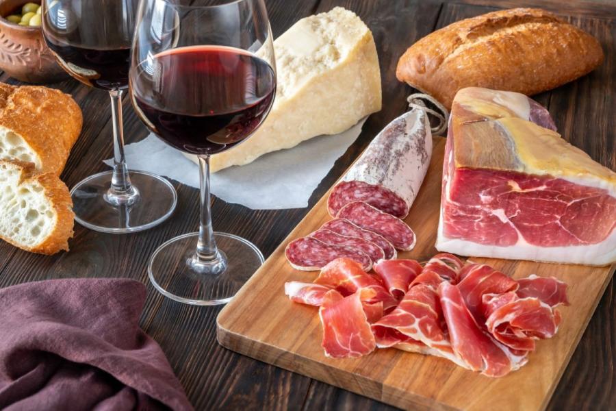 Embutidos, con prosciutto y salami, y vino tinto.