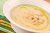 Crema especiada de garbanzos decorada con aceite de oliva y garbanzos cocidos.